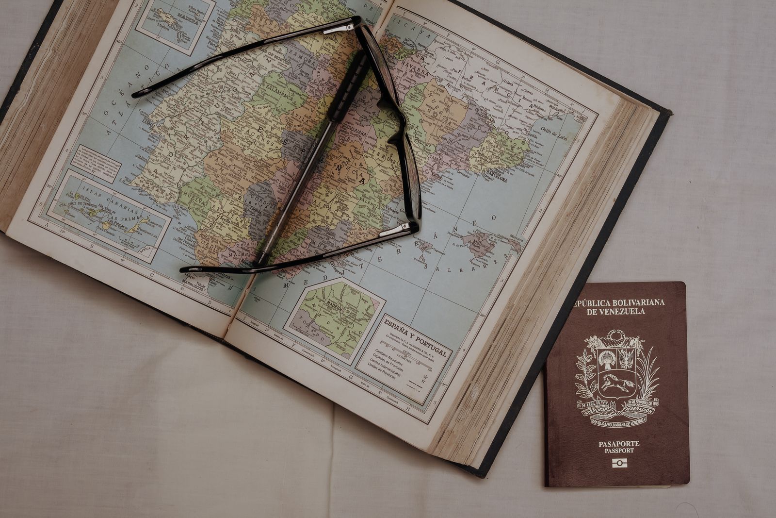 Pasaporte y mapamundi sobre una mesa que ilustran la libertad de movimiento internacional