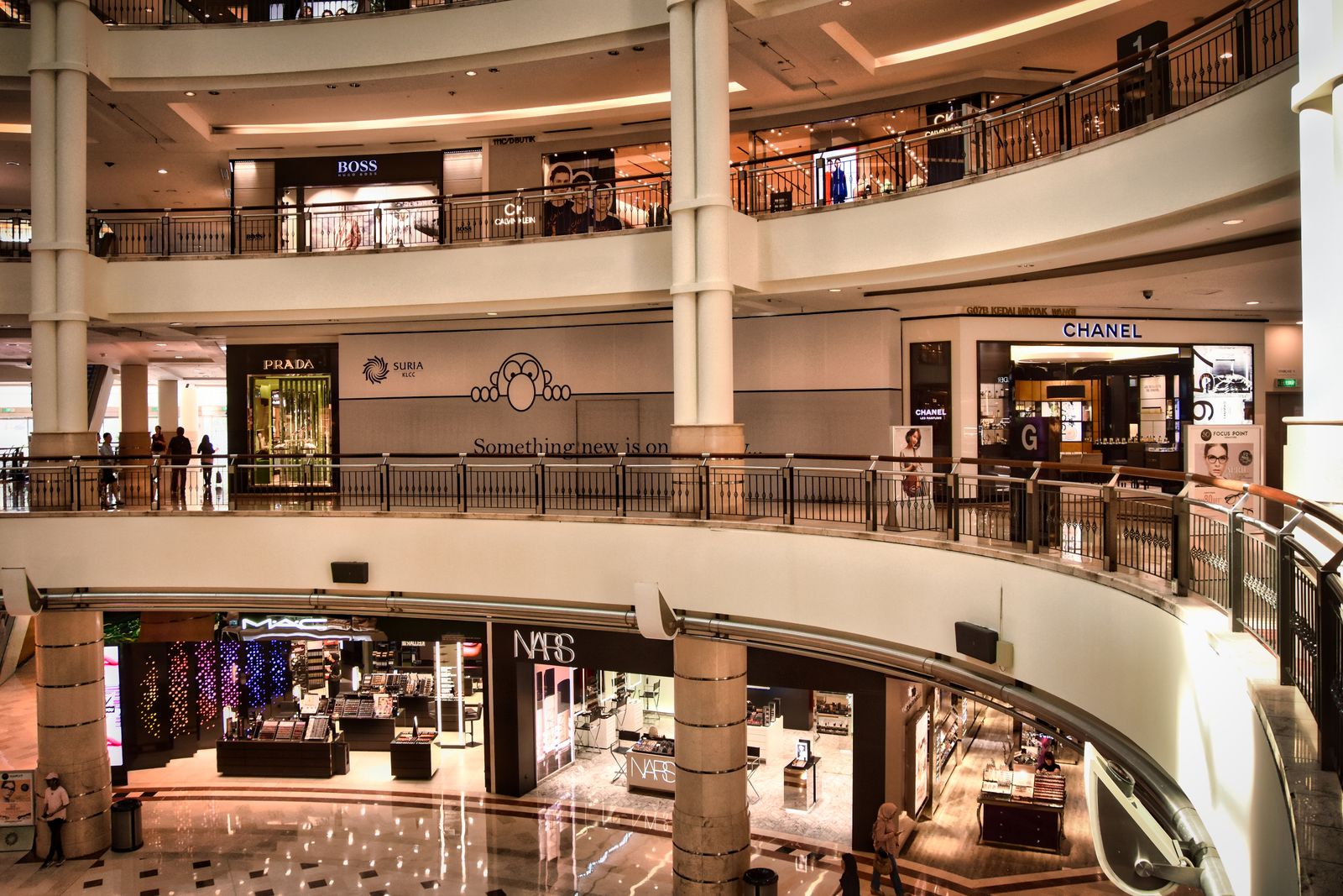 Interior de un centro comercial moderno con tiendas iluminadas y escaparates elegantes